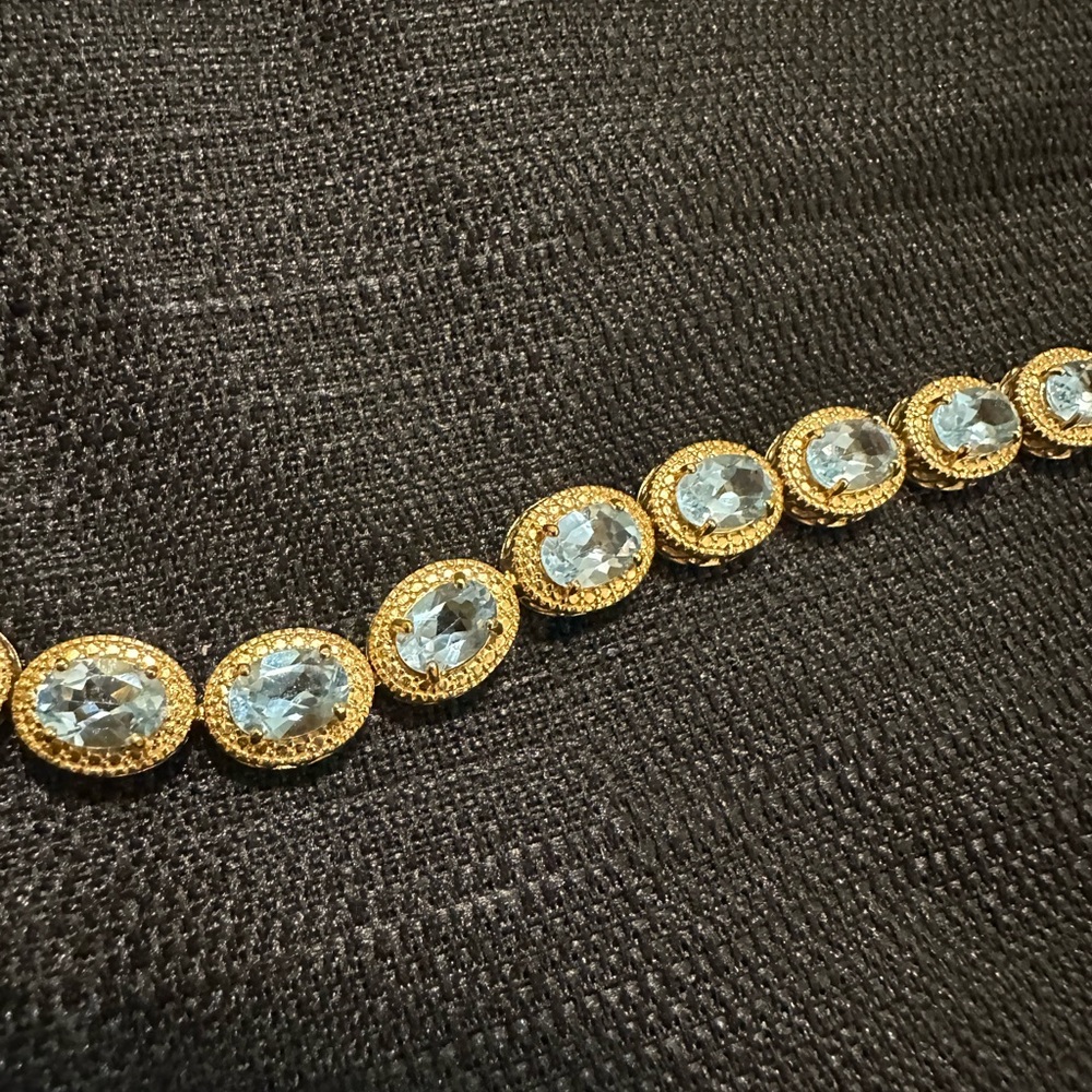Bold and beautiful gold 925 and blue topaz 7” tennis bracelet